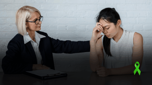 A faculty member gently supporting a student during a conversation. Text on image reads “Understanding, not judging.” Green awareness ribbon for World Mental Health Day, campaign by Oral Pathology 360.